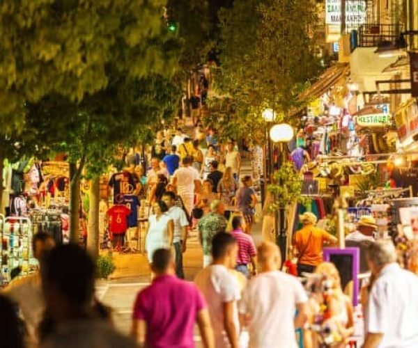 AGIOS NIKOLAOS, GREECE - JULY 28, 2012: Tourists walking along shopping streets after sunset